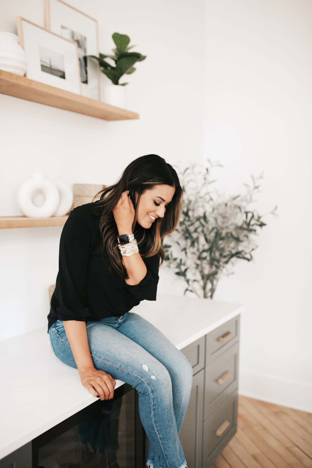 Jaime McLaughlin sitting on a countertop in her kitchen